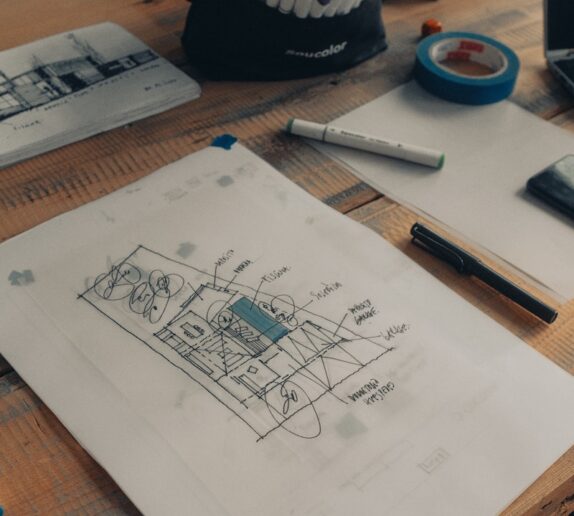 white printer paper beside pen and pen